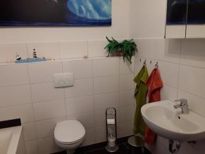 a bathroom with a toilet and a sink at Haus am Leuchtfeuer in Peenemünde