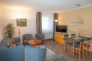 ein Wohnzimmer mit einem Sofa und einem Tisch in der Unterkunft Apartment 85 im Dünenpark in Binz