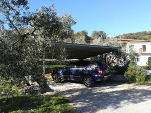 a car parked under a carport in a driveway at Villa La Pila Bilo in Marina di Campo