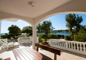 a porch with a view of the water at Apartments Simuni 66 in Šimuni