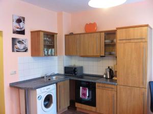 a kitchen with a sink and a washer in it at City Apartment in Nürnberg am Bahnhof in Nuremberg