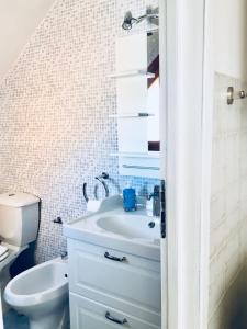 a bathroom with a sink and a toilet at La casa del sole sorgente in Letojanni