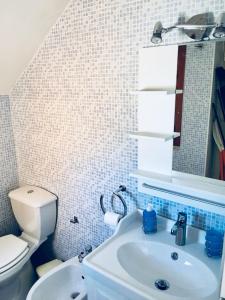 a bathroom with a sink and a toilet and a mirror at La casa del sole sorgente in Letojanni +29 photos