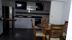a kitchen with a table and chairs and a microwave at Torres del rio in Armenia +2 photos