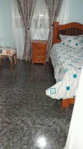 a bedroom with a bed and a dresser and a chair at Torres del rio in Armenia