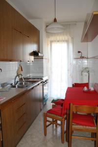 a kitchen with a table with a red table cloth at Da Federico in Trieste