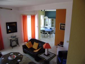 a living room with a couch and a dining room at Villa Kate in Vis