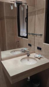 a bathroom with a sink and a mirror at Hostal Puerta del Valle in Valladolid