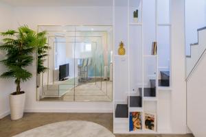 a living room with a mirror and a plant at Picasso Apartment in Lisbon