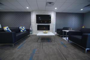 a waiting room with couches and a fireplace at Home Inn and Suites Memphis in Memphis