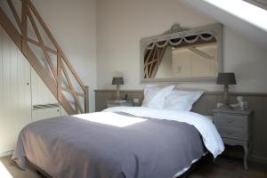 ein Schlafzimmer mit einem großen Bett und einem Spiegel in der Unterkunft B&B Cimbarsaca in Semmerzake