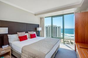 a bedroom with a bed and a large window with the ocean at Mantra Legends Hotel in Gold Coast +37 photos