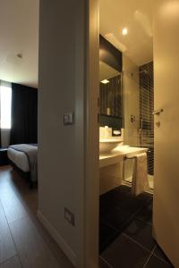 a bathroom with a sink and a mirror at Holiday Inn Milan Nord Zara, an IHG Hotel in Cinisello Balsamo