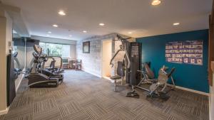 a gym with treadmills and cardio equipment in a room at Gibsons Garden Hotel in Gibsons