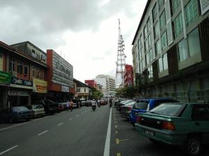 a city street with cars parked on the side of the road at Best Studio Guest House in Kota Bharu