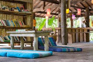 a table and some blue pillows on the floor at Forra Dive Resort Sunrise in Ko Lipe