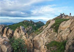 a group of people standing on top of a mountain at Home Inn Plus Qingdao Yinchuan West Road Software Park in Qingdao