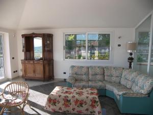 a living room with a couch and a table at Holiday Home Villa Bobolino in Montelupo Fiorentino +48 photos