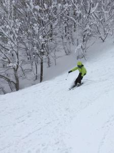 a person is skiing down a snow covered slope at Shiga Palace Hotel in Yamanouchi