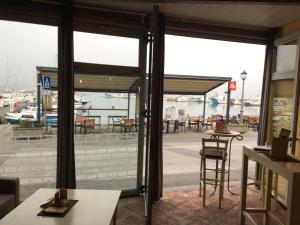a restaurant with a view of a patio with tables and chairs at Fontana in Izola