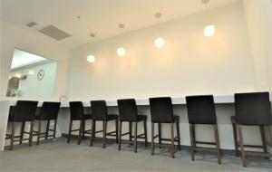 a row of black chairs in a waiting room at Inn Cube - Ximen in Taipei
