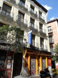 a building with a scooter parked in front of it at Hostal Fernandez in Madrid