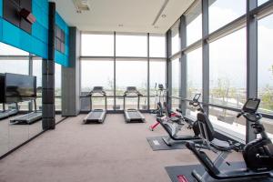 a gym with treadmills and cardio equipment in a building at Sun Hao International Hotel in Douliu