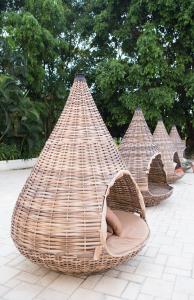 three wicker hammocks lined up in a row at Chiangmai Plaza Hotel in Chiang Mai