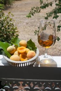 a bowl of fruit next to a glass of wine at Whiskey Gully Wines in Stanthorpe