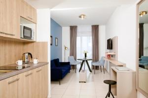a kitchen with a table and chairs and a refrigerator at Residhome Bordeaux in Bordeaux