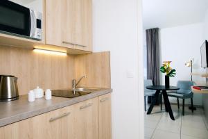 
a kitchen with a stove and a microwave at Residhome Bordeaux in Bordeaux
