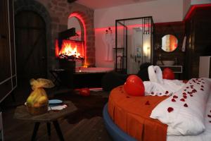 a room with a bed and a fireplace with red lights at Cephanelik Butik Hotel in Trabzon