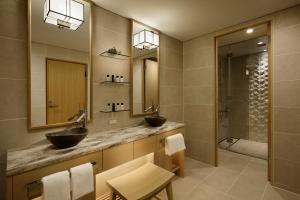 a bathroom with two sinks and a shower at Takanawa Hanakohro - in Grand Prince Hotel Takanawa in Tokyo