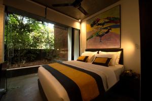 a bedroom with a large bed and a large window at BBQ HUB Ella in Ella