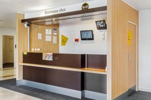 an entrance to a dental office with a reception desk at B&B HOTEL Lyon Grand Stade Meyzieu in Meyzieu