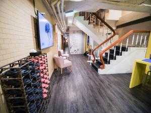 a hallway with a staircase and a room with shoes at King Wow Inn in Tainan