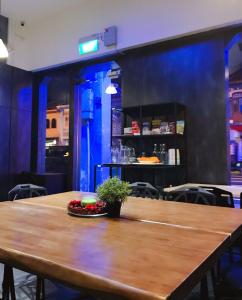 a large wooden table in a restaurant with a table sidx sidx at Atlantis Pods @ Little India in Singapore