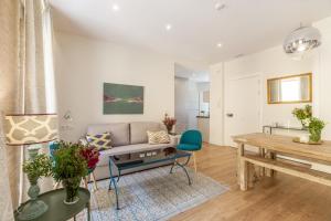 a living room with a couch and a table at Apartamentos RG Suites Jardines de Murillo in Seville