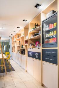 a kitchen with shelves and a counter in a restaurant at Aparthotel Adagio Access Paris Porte De Charenton in Charenton-le-Pont