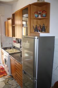 a kitchen with a stainless steel refrigerator and wooden cabinets at Santa Margherita Ligure Apartment with parking in Santa Margherita Ligure