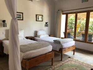 Posteľ alebo postele v izbe v ubytovaní Tamani Villas - Annex