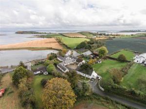 an aerial view of a large house next to the water at Tracey's Farmhouse Cottage in Belfast