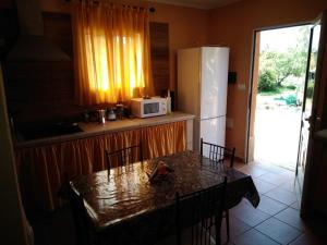 a kitchen with a table with chairs and a refrigerator at Casa roko in Puntagorda
