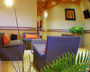 a room with two chairs and a couch and a plant at Hôtel Serena in Toliara