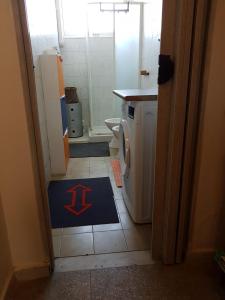 a bathroom with a toilet and a rug on the floor at mare e arte in Marina di Pisa