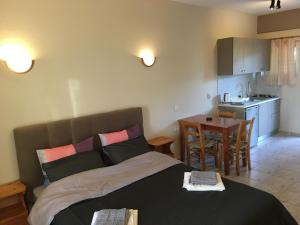 a living room with a bed and a kitchen at Kastraki Studios in Stoupa