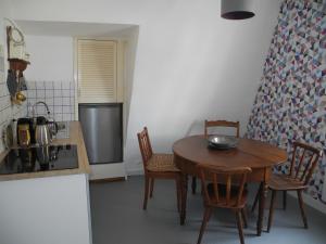 a kitchen with a table and chairs in a kitchen at Apartment Lollo in Enkirch