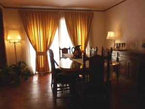 a dining room with a table and a window at 816 B&B in Mendoza