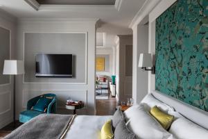 a hotel room with a bed and a tv at Vista Palazzo - Small Luxury Hotels of the World in Como