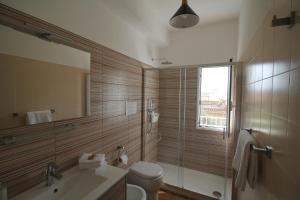 a bathroom with a toilet and a sink and a mirror at Colori a mare in Villaggio Azzurro +61 photos